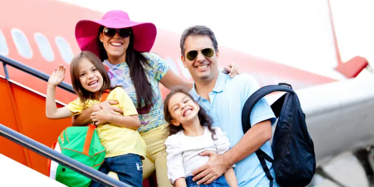 Travelers posing for a group photo with backpacks.
