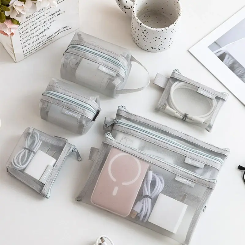 Grey mesh travel organizer pouches holding cables chargers and small electronic accessories