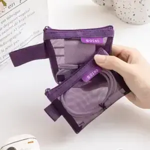 Purple mesh travel organizer pouch open with charging cables and electronic accessories
