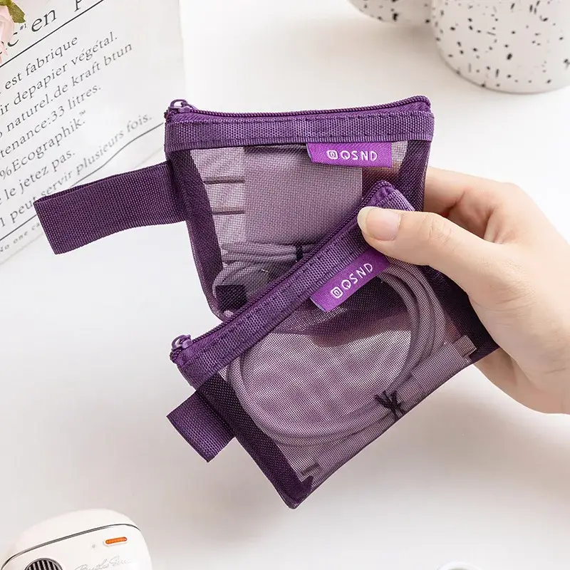 Purple mesh travel organizer pouch open with charging cables and electronic accessories