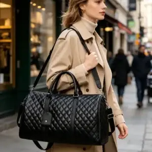 Black travel duffle bag carried over the shoulder for short trips and overnight travel