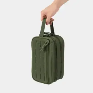 Hand holding an olive green zippered organizer pouch by its webbing handle