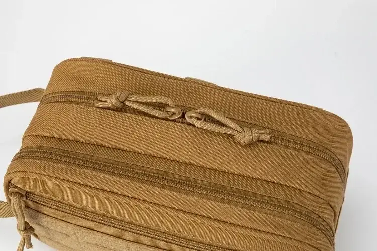 Close-up of tan organizer pouch zipper tracks and cord pull tabs