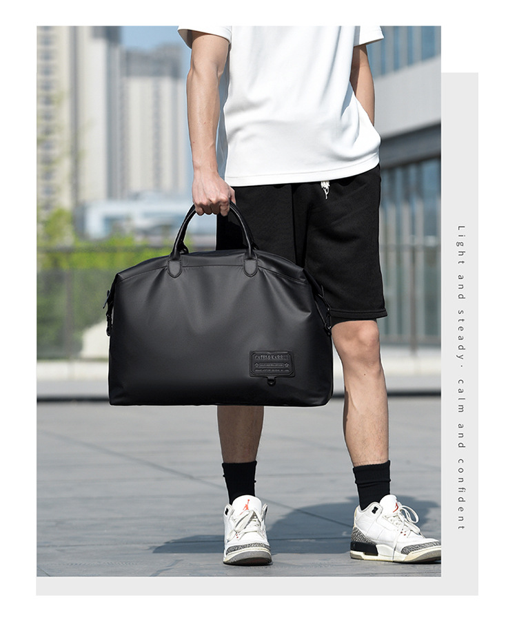 Traveler holding a black tote bag by its top handles
