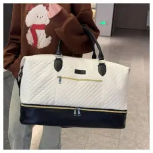 Cream quilted duffel travel bag with lower storage compartment